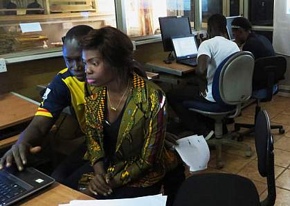 West Africans working on a computer.